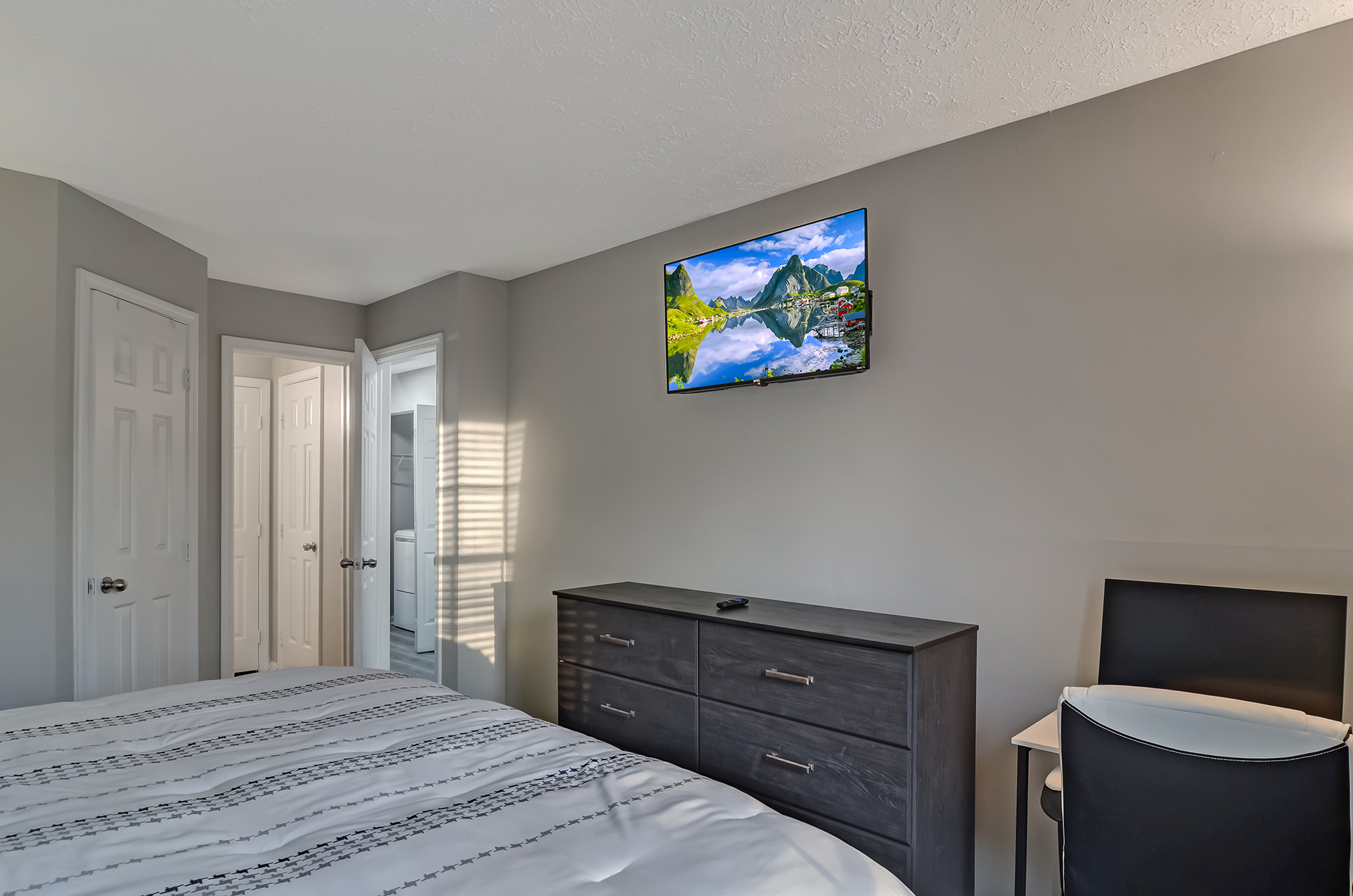 Large bedroom with mounted smart tv