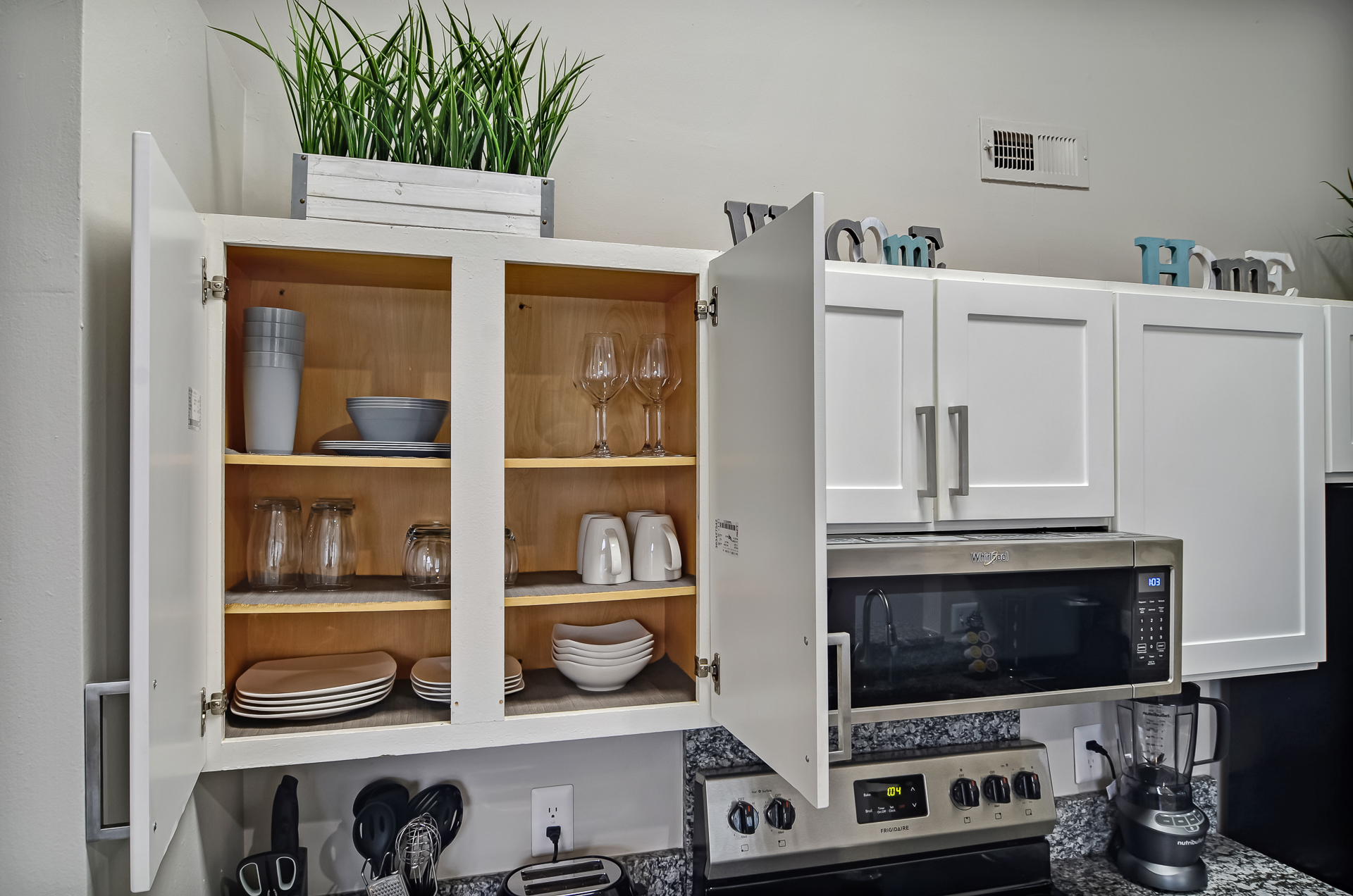 fully stocked kitchen cabinets with plates